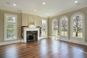 Living room in new construction home with marble fireplace and large windows
