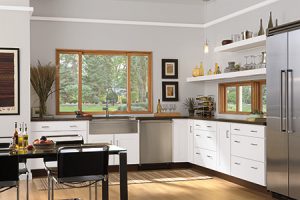 Wood Windows with having cabinets all around the kitchen.