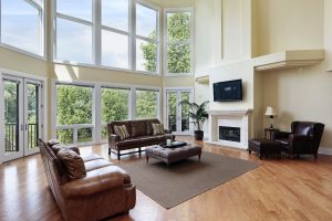 Living room in luxury home with with floor-to-ceiling windows