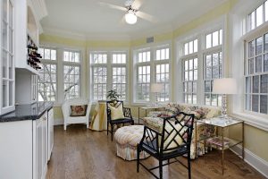 Sun room in upscale home with wall of windows.