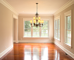 A spacious home interior with expansive windows and an attractive chandelier.