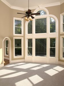 A sunny room with unique wood windows