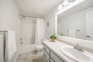 A modern bathroom with a white color scheme and a new acrylic bathtub.